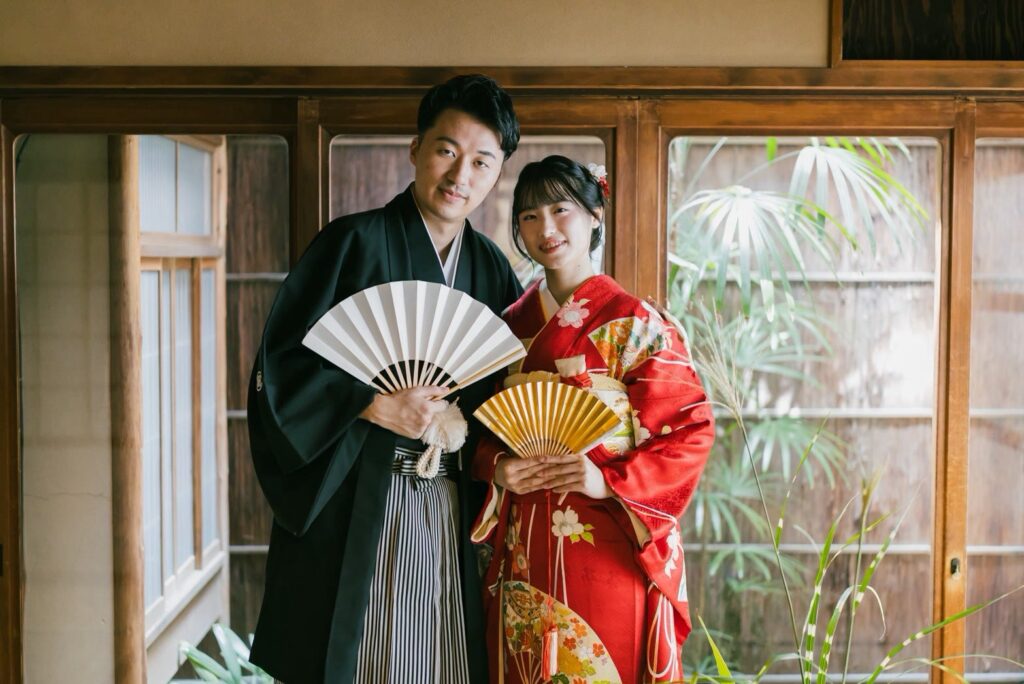 玄想庵で引振袖と紋付袴の和装の前撮り（扇子を手に窓辺で）